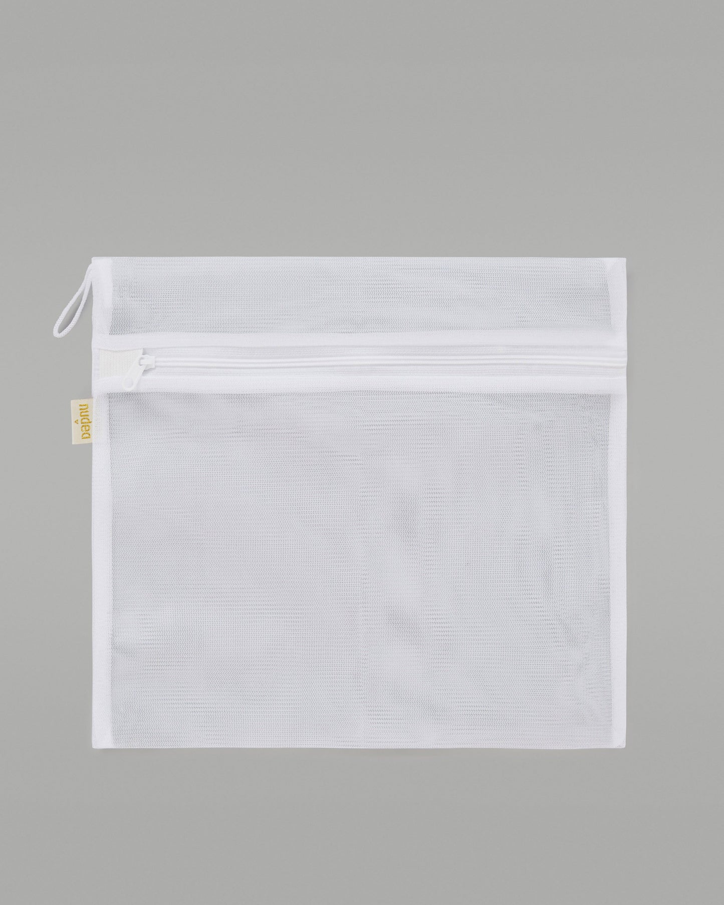 A NUDEA laundry bag in white, used for washing lingerie