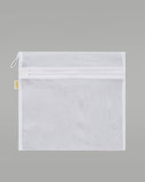 A NUDEA laundry bag in white, used for washing lingerie