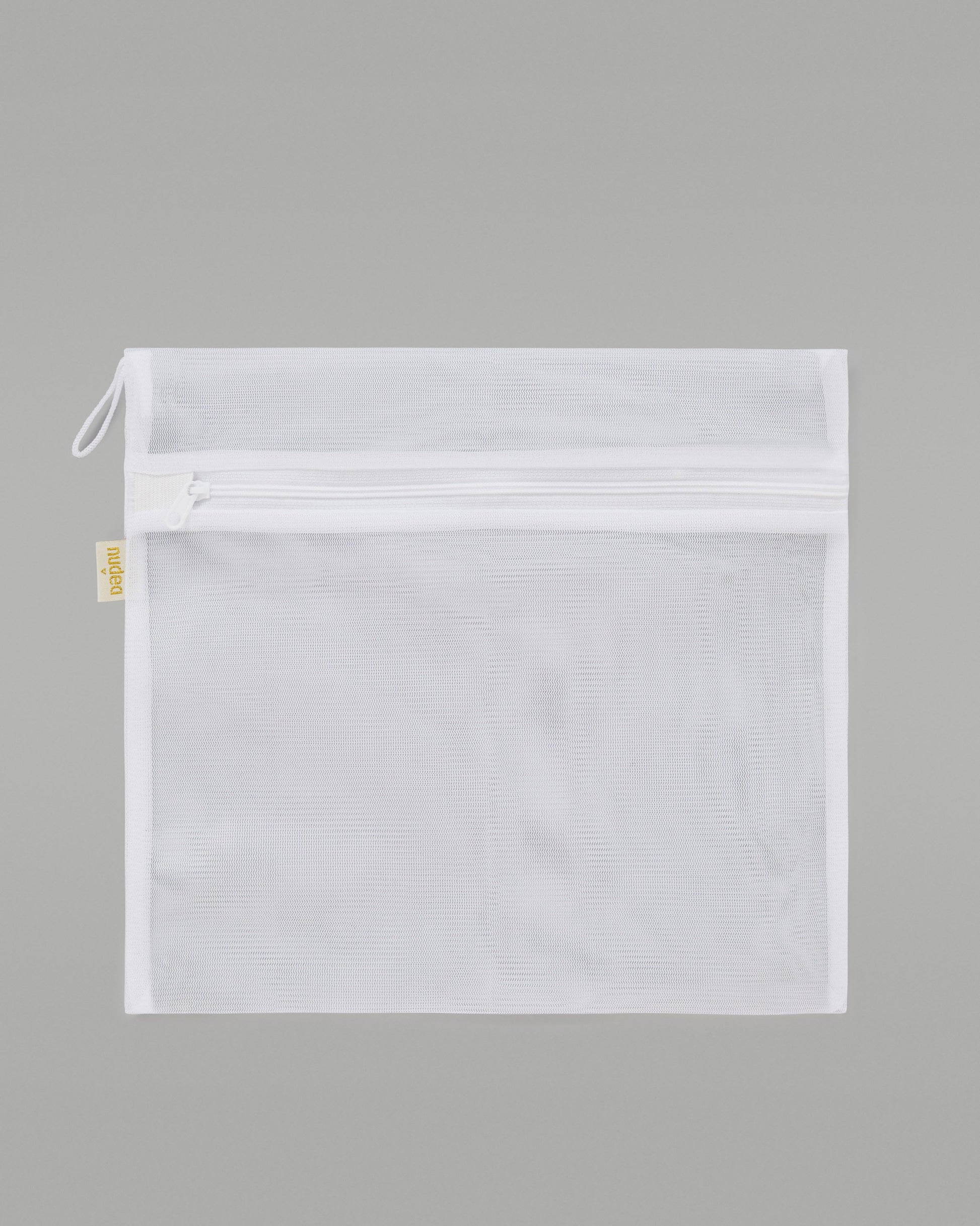 A NUDEA laundry bag in white, used for washing lingerie